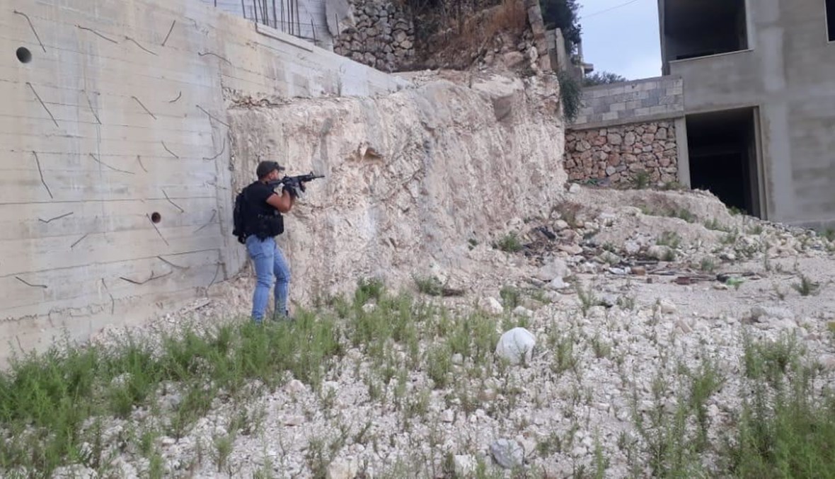 An Army Intelligence member during the raid of Ahmad Al-Shami's hideout.