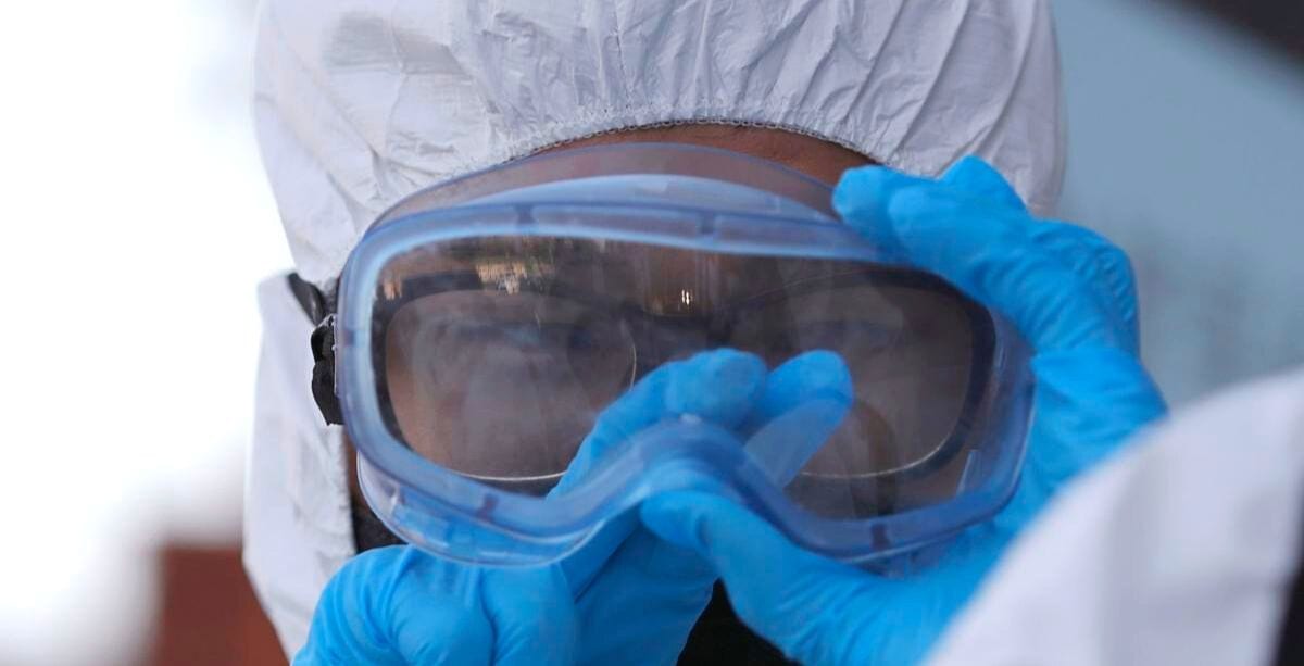 Medical professional sterilizing goggles to avoid coronavirus infection