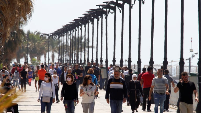 Lebanese people strolling on a Beirut sidewalk during coronavirus pandemic