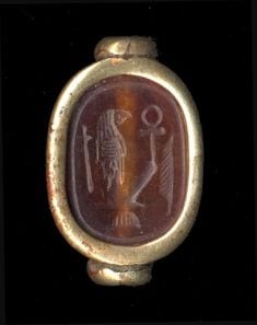 An ancient gold and onyx scarab seal