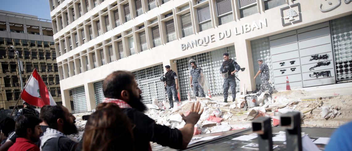 Protesters rally in front of the central bank in Beirut