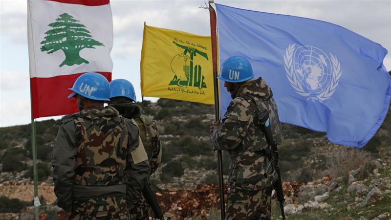 The flags of Lebanon, Hezbollah, and the UN in South Lebanon.