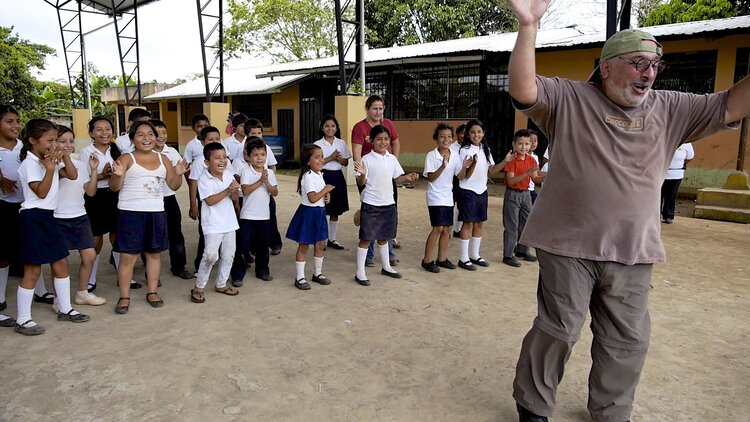 Guy Debbas entertaining a group of pupils.