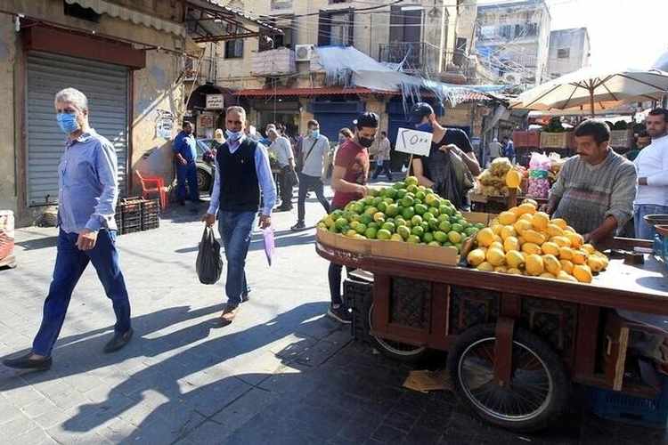 People walk at a souk, as the Lebanese government ordered a national lockdown, to combat a resurgence of the coronavirus disease (COVID-19) outbreak, in Sidon, Lebanon November 16, 2020.