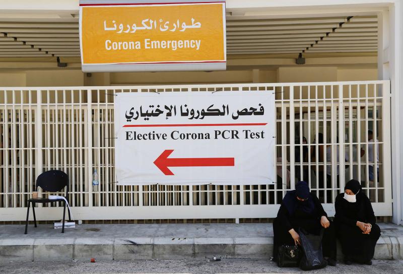 Women wait outside a hospital in Beirut.