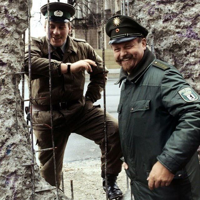 The Story Of The Lebanese Man Who Protested The Berlin Wall With A Giant Wooden Cross 4 A border guard of the German Democratic Republic and a policeman of the Federal Republic of Germany at the Berlin Wall 1990