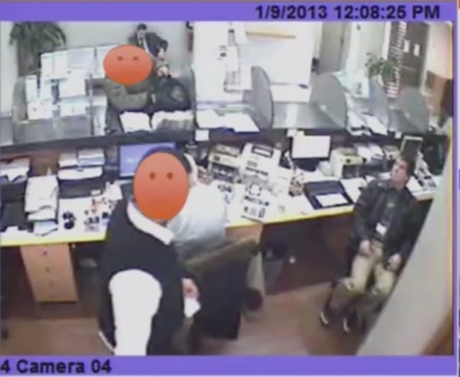 Jayson E. Street, right, spinning in an office chair behind the teller line in the bank in Beirut.
